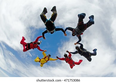 Skydiving holding hands friends