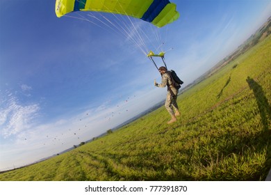 skydiving landing in blue sky