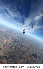 Skydiving people in freefall in sunny day