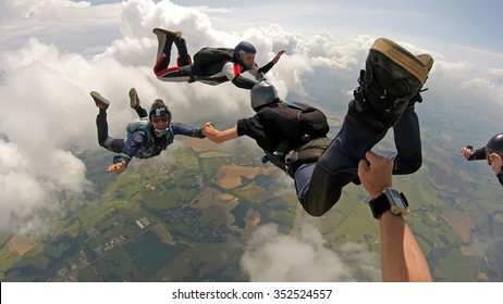 Skydiving Point Of View. Young And Middle Aged Friends, Having Fun. Soft Focus.