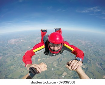 Skydiving Senior Man Holding Hands