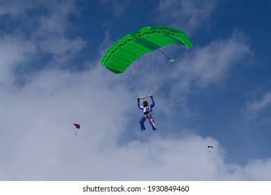 Skydiving. A Skydiver Is Flying A Parachute In The Blue Sky.