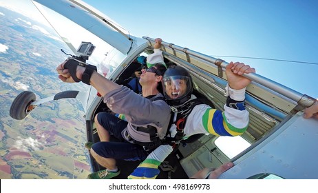 Skydiving Tandem At The Door Of The Plane