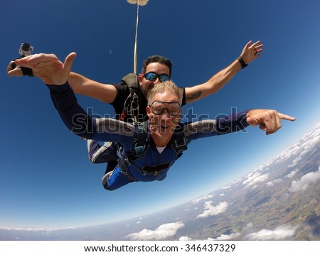Skydiving tandem happiness middle aged man