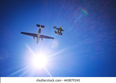 Skydiving tandem happiness. Portrait of two tandem skydivers in action parachuting through the air
