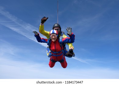 Skydiving. Tandem Jump. Asian Woman And Instructor.