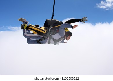 Skydiving. Tandem jump. Man and woman are flying in the sky. - Shutterstock ID 1132508522