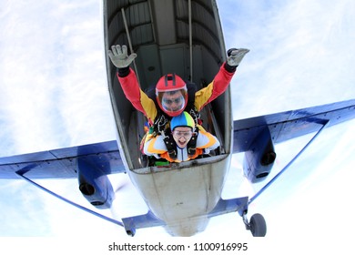 Skydiving. Tandem Is Jumping Out Of A Plane.