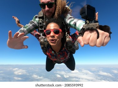 Skydiving Tandem Parachute Jump. Beautiful Fashion Woman.