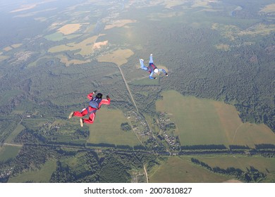 Skydiving. Two skydivers are in the sky.