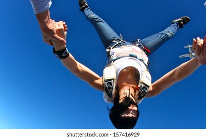 Skydiving Woman In Head Down Position, Wide Angle Point Of View. Freedom Concept