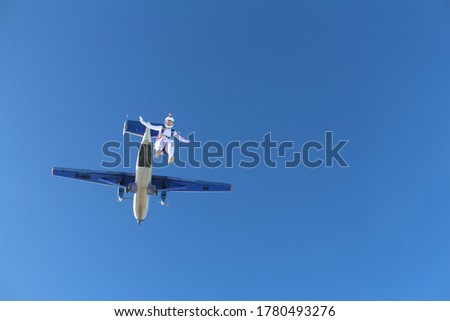Skydiving. A young woman has just jumped out of a plane into the blue sky. Foto stock © 