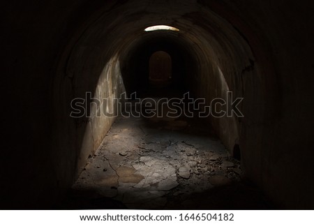 Skylight in the ceiling of the late tunnel and exit at the end of a dark underground passage at Fort Pospelova on the Russian island in Vladivostok.