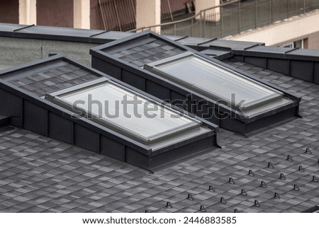 Skylight windows on a new tiled roof on a residential block.