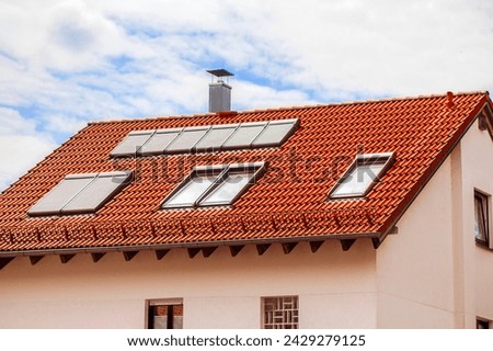Skylights Roof Windows Dormers with Shutters Outdoor on Red Tiles Roof of Private House on Sky Background.