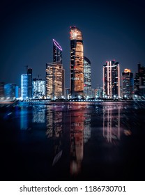 Skyline Of Abu Dhabi At Night With Water Reflection! 