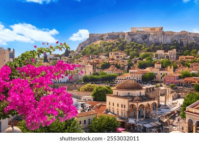 Skyline of Athens with Monastiraki square and Acropolis hill during sunset. Athens, Greece. Pink bougainvillea flower in the foreground.