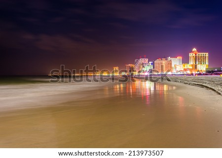 The skyline and Atlantic Ocean at night in Atlantic City, New Jersey.