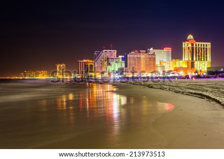 The skyline and Atlantic Ocean at night in Atlantic City, New Jersey.