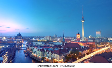 Skyline Of Berlin in Germany with TV Tower, Berlin Town Hall and a busy street in the evening