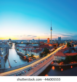 Skyline Of Berlin in Germany with TV Tower, Berlin Town Hall and a busy street in the evening