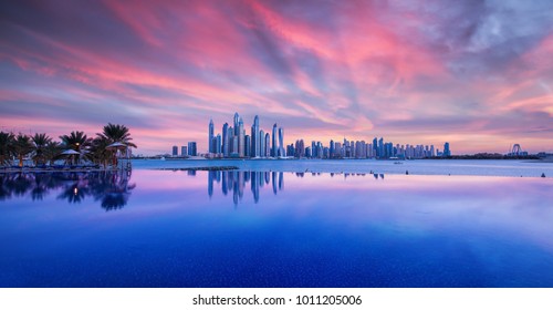 Skyline Of Dubai Marina At A Beautiful Sunset With An Infinity Pool In Front