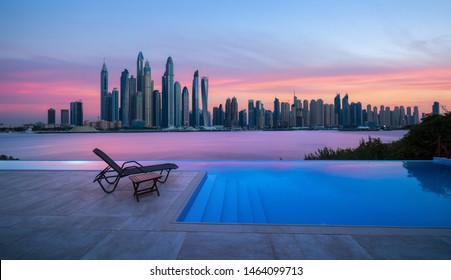 Skyline Of Dubai Marina At A Beautiful Sunset With An Infinity Pool In Front