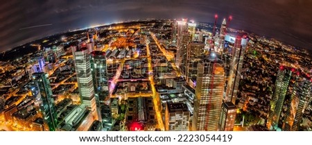 The skyline with the houses and streets of Frankfurt am Main at night and artificial lighting