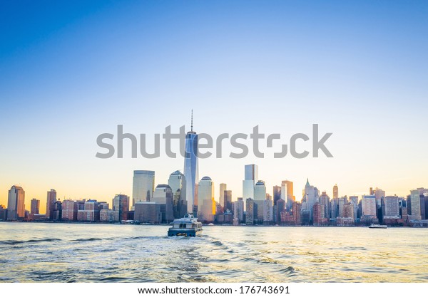 Skyline of lower Manhattan of New York City from\
Exchange Place at night with World Trade Center at full height of\
1776 feet May 2013