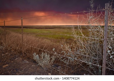 The Skyline Of Malibu Is Orange From The Wildfires Spreading Across The Landscape.