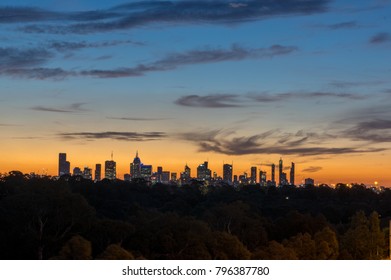 Skyline Of Melbourne Australia At Dusk, Looking West From The Eastern Suburbs On Yarra Boulevard In Kew.