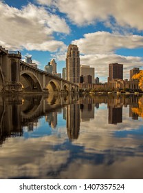 skyline of Minneapolis reflected in Mississippi River