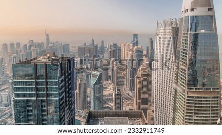 Skyline panoramic view of Dubai Marina showing an artificial canal surrounded by skyscrapers with glass surface along shoreline aerial at morning. Floating yachts and boats. DUBAI, UAE