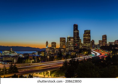 Skyline Seattle With Traffic On The Freeway At Night