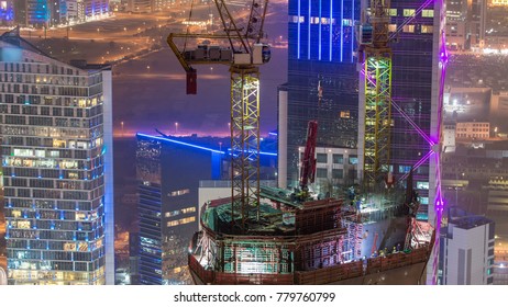 Skyline With Skyscrapers And Construction Process Night Timelapse In Kuwait City Downtown Illuminated At Dusk. Kuwait City, Middle East. View From Rooftop