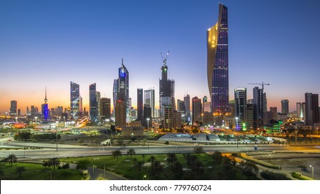 Skyline with Skyscrapers day to night transition timelapse in Kuwait City downtown illuminated at dusk. Kuwait City, Middle East. View from rooftop