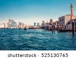 Skyline view of Dubai Creek with traditional boats and piers. Sunny summer day. Famous tourist destination in UAE. Creative color post processing.