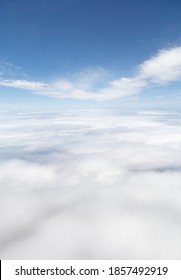 Skyscape, aerial view above Earth covered with a blanket of cloud and blue sky above. Ideal for an environment template or background.