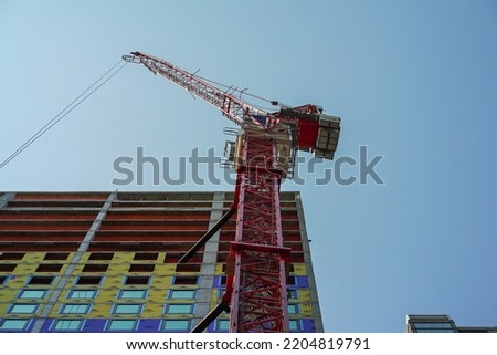 Skyscraper being built in manhattan with crane in frame