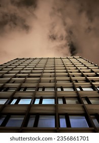 skyscraper by night with clouds