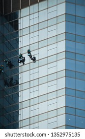 Skyscraper Cleaning Team. Professional Window cleaner service on high rise building. Dangerous high risk worker.