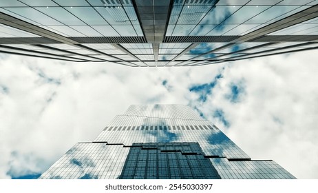 Skyscraper with Cloud Reflections in Glass Facade. Upward view of a modern skyscraper with reflective glass panels, mirroring clouds and sky, creating an abstract architectural effect. - Powered by Shutterstock