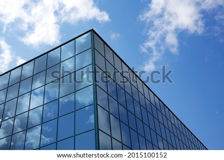 skyscraper with clouds reflections in glasses corporation growth future finance