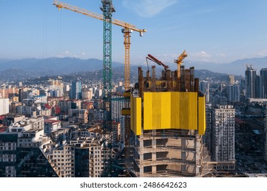 Skyscraper Construction with Cranes in Cityscape
