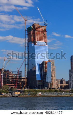 Skyscraper construction on cloudy sky over the Hudson River in Manhattan, New-York, USA