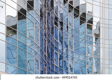 Skyscraper Mirror Glass Surface Reflecting Cloudy Sky, Curvy Surface