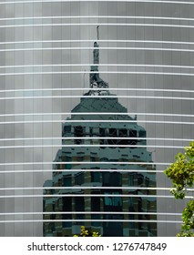 Skyscraper reflections and tree