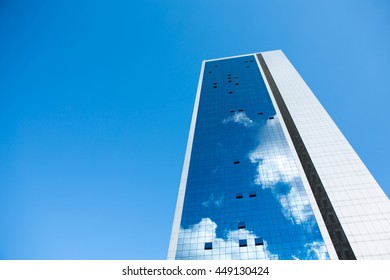 Skyscrapers with clouds reflection.