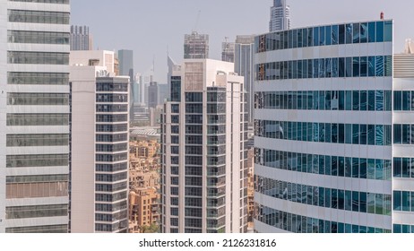 Skyscrapers in Dubai Business Bay and financial district aerial timelapse. Skyline with office towers and construction site in downtown