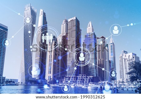 Skyscrapers of Dubai business downtown. International hub of trading and financial services. Social network icons hologram, concept of people connection. Double exposure. Dubai Canal waterfront.